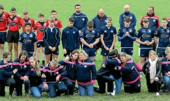  ?? AP ?? Players and club officials observe a minute’s silence at East Grinstead rugby club to pay their respects to slain police officer Sergeant Matt Ratana, who was the head coach at the club in Kent, England.