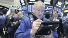  ?? [AP PHOTO] ?? Trader Richard Newman works on the floor of the New York Stock Exchange on Wednesday.