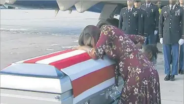  ?? WPLG ?? MYESHIA JOHNSON grieves over the casket of her husband, Army Sgt. La David T. Johnson, in Miami.