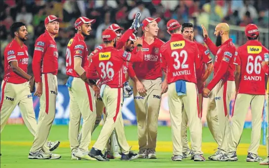  ?? PTI ?? King's XI Punjab players celebrate the fall of RCB’s Kedar Jadhav in Bangalore on Friday. KXIP won scoring 138, the lowest ever total defended in Bangalore.