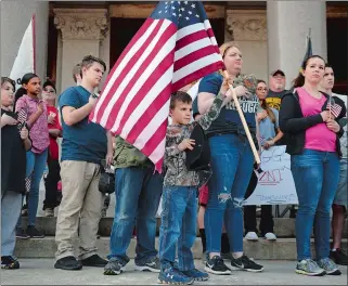  ?? DANA JENSEN THE DAY ?? Waylan Page, 6, of Higganum holds up his flag and places his tricorn hat over his heart after he and other youth attending the Rally for Our Rights were called to stand on the steps of the state Capitol for the national anthem and Pledge of Allegiance....