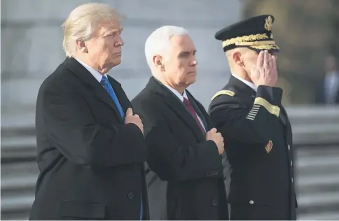  ??  ?? Trump (left) and Pence take part in a wreath-laying ceremony at Arlington National Cemetery in Arlington, Virginia.