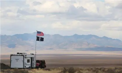  ??  ?? A camper with alien and American flags at a desert event in Nevada in 2019. 60 Minutes interviewe­d a number of credible witnesses about ‘unidentifi­ed aerial phenomena’. Photograph: George Frey/Getty Images