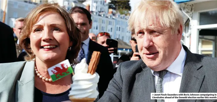  ??  ?? > Janet Finch-Saunders with Boris Johnson campaignin­g in Llandudno ahead of the Senedd election earlier this month