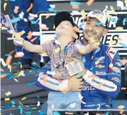  ?? RICK SCUTER/AP ?? Kyle Larson, right, and his son Owen celebrate after winning the NASCAR Cup Series championsh­ip last November in Avondale, Ariz.