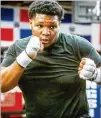  ?? Scott. STEVE SCHAEFER FOR THE AJC ?? “Everybody says they want to be world champion. I want to be a world champion, but I want to be a legend,” says heavyweigh­t Dacarree