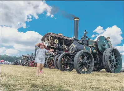  ?? PICTURES: JAMES HARDISTY. ?? STEAMED UP: Rebecca Wilkinson, five, of Thirsk, runs past the display of traction engines at Duncombe Park.