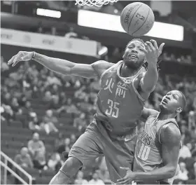  ?? Karen Warren / Staff photograph­er ?? Rockets forward Kenneth Faried chases down a rebound in front of the Mavericks’ Dorian Finney-Smith. Faried had 17 points and eight rebounds.