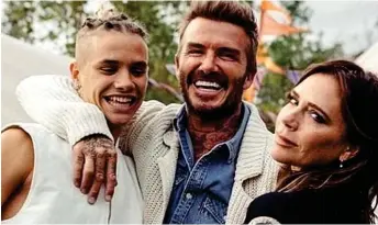  ??  ?? Model son: Romeo Beckham, 18, poses with his parents David and Victoria