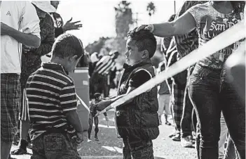  ?? GUILLERMO ARIAS/GETTY-AFP ?? Central American migrants wait at the U.S.-Mexico border in Tijuana. The U.S. is seeking a solution to the border crisis.