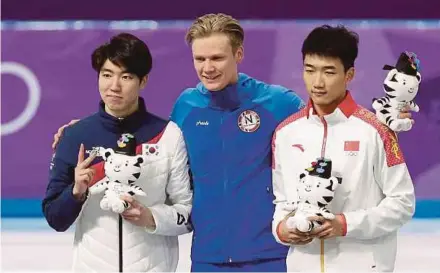  ?? EPA PIC ?? (Left to right) Speed Skating 500m silver medal winner Cha Min-Kyu of South Korea, gold medallist Havard Lorentzen of Norway and bronze medallist Gao Tingyu of China after the competitio­n yesterday.