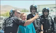  ??  ?? Democratic presidenti­al nominee Hillary Clinton takes a selfie with a police officer in Nevada on Thursday.