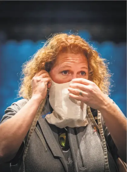  ?? Josh Edelson / Special to The Chronicle ?? Dr. Sanziana Roman displays a custommade mask for San Francisco Opera singers developed by medical staff at UCSF, which allows for singing while wearing a mask.