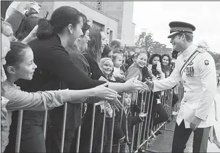  ??  ?? Britain’s Prince Harry shakes hands with members of the public during a visit to the Australian War Memorial in Canberra, Australia, April 6. Prince Harry, or Captain Harry Wales as he is known in the British Army, will end his military career with a...