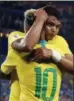  ?? REBECCA BLACKWELL — THE ASSOCIATED PRESS ?? Brazil’s Thiago Silva, face to camera, celebrates with teammate Neymar after scoring his side’s second goal against Serbia in Moscow on Wednesday.