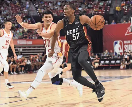  ?? STEPHEN R. SYLVANIE-USA TODAY SPORTS ?? Miami Heat guard Jeremiah Martin (57) dribbles against Chinese National Team guard Minghui Sun (17) during an NBA Summer League game in Las Vegas on Friday.