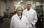  ?? AP PHOTO/SETH WENIG ?? Ollie co-founders Gabby Slome and Alex Douzet pose for a picture at the manufactur­ing facility where their dog food is made in Woodbridge, N.J.