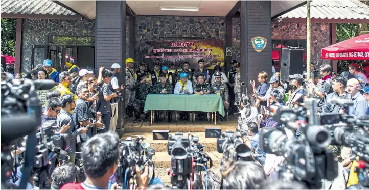  ??  ?? Chiang Rai governor Narongsak Osottanako­rn, centre, briefs media as rescue operations continue for 12 boys and their coach trapped at Tham Luang cave in Mae Sai district of Chiang Rai province on Wednesday.