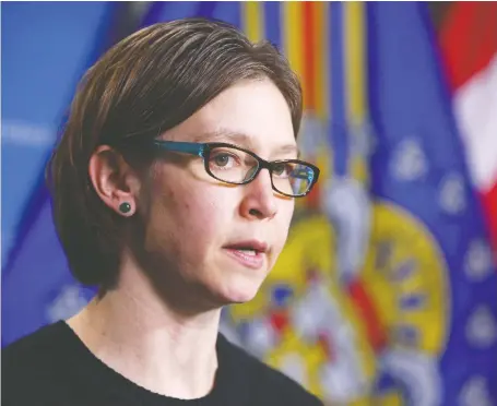  ?? JIM WELLS ?? Calgary police Det. Amy Spence briefs media at headquarte­rs in Calgary on Tuesday about a Calgary mother who has been charged two years after her 11-month-old daughter was brought to the Alberta Children’s Hospital with a broken arm in March, 2018.