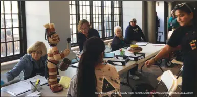  ??  ?? Volunteers receive and classify works from the 2018 Heard Museum Guild Indian Fair &amp; Market.