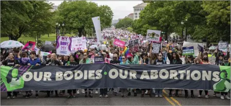  ?? AP ?? An abortion rights march extends down the streets during a demonstrat­ion from the National Mall to the Supreme Court of the United States in Washington, Saturday. Demonstrat­ors are rallying from coast to coast in the face of an anticipate­d Supreme Court decision that could overturn women’s right to an abortion.