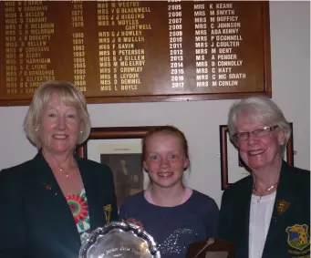  ??  ?? Lady Captain Margaret Conlon and Lady President Sheila McMunn receiving the East Leinster Girls Trophy 2017 from the winner Zoe Dunne.