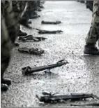  ?? NURELDINE/AFP FAYEZ ?? Weapons are seen lying on the ground as members of the Saudi special police unit perform during a parade in Mecca, Saudi Arabia, on October 9, 2013.