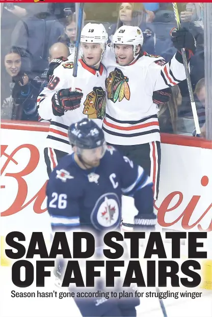  ?? | AP ?? Brandon Saad ( right, with Jonathan Toews) celebrates the only goal he has scored in his last 14 games Thursday against the Jets.