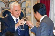  ?? SHIZUO KAMBAYASHI / ASSOCIATED PRESS ?? Vice President Mike Pence toasts with Japanese Prime Minister Shinzo Abe at the opening of a state banquet hosted by Abe at Abe’s official residence in Tokyo on Wednesday.