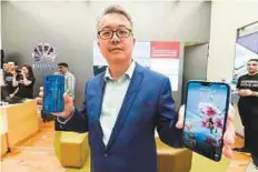  ?? Antonin Kélian Kallouche/Gulf News ?? ■ David Wang holds the new Huawei nova 3e at the Huawei Experience Store at Dubai Mall. He said opening the store has enabled Huawei to communicat­e with customers.