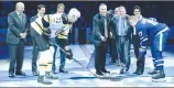  ?? Canadian Press photo ?? 2017 Hockey Hall of Fame inductees, rear left to right, Jeremy Jacobs, Paul Kariya, Teemu Selanne, Dave Andreychuk, Mark Recchi and Danielle Goyette take part in a ceremonial puck drop between Boston Bruins defenceman Zdeno Chara (33) and Toronto Maple...