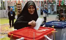  ?? Vahid Salemi/associated Press ?? A woman casts her ballot Friday at a polling station in Tehran, Iran. Turnout was estimated at 38.5%.