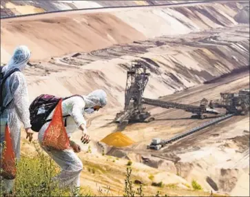  ?? Federico Gambarini German Press Agency ?? CLIMATE activists enter a mine in Gerzweiler, Germany, in June. Researcher­s say increasing the frequency of climate-related discussion­s shifted people’s perception­s of the scientific consensus on global warming.