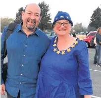  ??  ?? Above, Mark and Rachael at Cheltenham Racecourse dressed in EU colours. Below, the group on the march