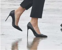  ?? AFP ?? First Lady Melania Trump walks on high heels to board Air Force One at Andrews Air Force Base, Maryland, on Tuesday en route to Texas to view the damage caused by Hurricane Harvey.—