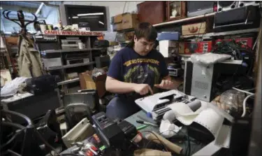  ?? ROBERT F. BUKATY — THE ASSOCIATED PRESS ?? Chaz Wing types labels for electronic equipment he fixes and sells at a flea market in Brunswick, Maine. From almost his first day at Brunswick Junior High, Chaz said kids harassed him. Complainin­g to teachers and administra­tors didn’t help, he said....