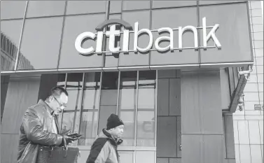  ?? PROVIDED TO CHINA DAILY ?? Pedestrian­s walk past a Citibank branch in Beijing.