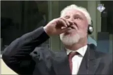  ?? ICTY VIA AP ?? In this photo provided by the ICTY on Wednesday, Slobodan Praljak brings a bottle to his lips, during a Yugoslav War Crimes Tribunal in The Hague, Netherland­s. Praljak yelled, “I am not a war criminal!” and appeared to drink from a small bottle,...