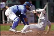  ?? CHARLIE RIEDEL — THE ASSOCIATED PRESS ?? The A’s Mark Canha slides home to score on a single by Chad Pinder during the third inning against the Royals on Thursday in Kansas City.