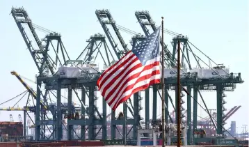  ??  ?? The US flag flies at the Port of Long Beach, in Los Angeles County The ISM’s non-manufactur­ing index jumped three points to 59.7 per cent from 56.7 per cent in the prior month, well above the consensus estimate of economists and above the 12-month average. Anything above 50 per cent indicates growth. — AFP photo