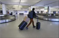  ?? RAY CHAVEZ — STAFF ARCHIVES ?? A solo traveler heads to the gates to depart from the Oakland Internatio­nal Airport in Oakland in 2020.