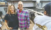  ??  ?? Siblings Rhonda and Irwin Shalfman, owners of Fairmount Bagel in Mile End, are photograph­ed Sept. 5, 2019, two days before the store turns 100 years old, while baker Sathees Serarajah tosses a row of finished bagels into a basket.