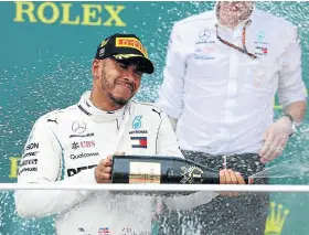  ?? Picture: MARK THOMPSON/GETTY IMAGES ?? LUCKY DAY: Race winner Lewis Hamilton, of Great Britain and Mercedes GP, celebrates on the podium during the Azerbaijan Formula One Grand Prix at the Baku City Circuit yesterday