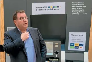  ?? STUFF ?? Finance Minister Grant Robertson with the multi-bank Smart ATM at Martinboro­ugh’s Waihinga Centre yesterday.