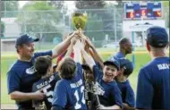  ?? STAN HUDY — SHUDY@DIGITALFIR­STMEDIA.COM ?? Saratoga Little League minor champions Julie & Co. Realty reach up for a chance to touch the Adirondack Cup after defeating Glens Falls minors champs Hudson River Community Credit Union Saturday night at West Side Recreatioa­nl Fields.