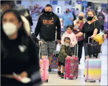  ?? PHOTO BY AXEL KOESTER ?? Travelers check in their luggage at Terminal 7 on the eve of what is expected to be a busy Independen­ce Day weekend at LAX on Friday.