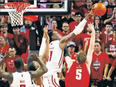  ?? Getty Images ?? BLOCK PARTY: Clifford Omoruyi sends back this offering from Wisconsin’s Tyler Wahl on Saturday in Piscataway, N.J. Rutgers’ 22-point win was its largest margin of victory against a ranked opponent ever.