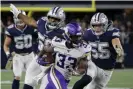  ??  ?? Vikings running back Dalvin Cook (33) runs the ball as the Cowboys’ Robert Quinn (58) and Leighton Vander Esch (55) give chase during Sunday’s first half. Photograph: Michael Ainsworth/AP