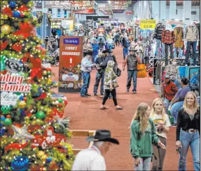  ?? L.E. Baskow Las Vegas Review-journal @Left_eye_images ?? Shoppers take a look on opening night Wednesday of the Cowboy Channel Cowboy Christmas at the Las Vegas Convention Center.