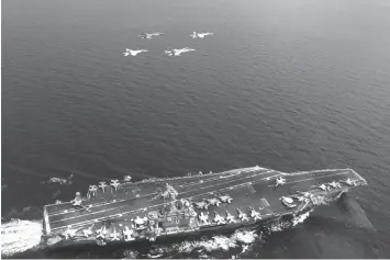  ?? AGENCE FRANCE PRESSE ?? US and Malaysian fighter jets fly over the aircraft carrier USS Carl Vinson during a joint exercise earlier in May in the South China Sea.